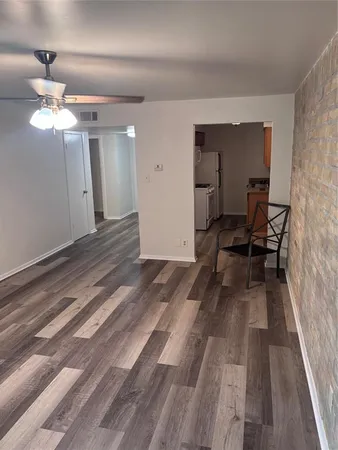 a view of a livingroom with furniture and wooden floor