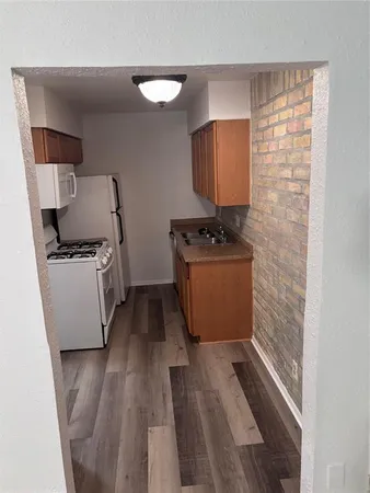 a room with wooden floor and cabinets