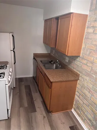 a kitchen with a sink and a stove top oven