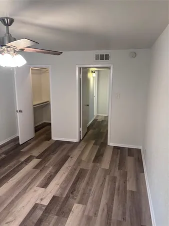 a view of a room with wooden floor