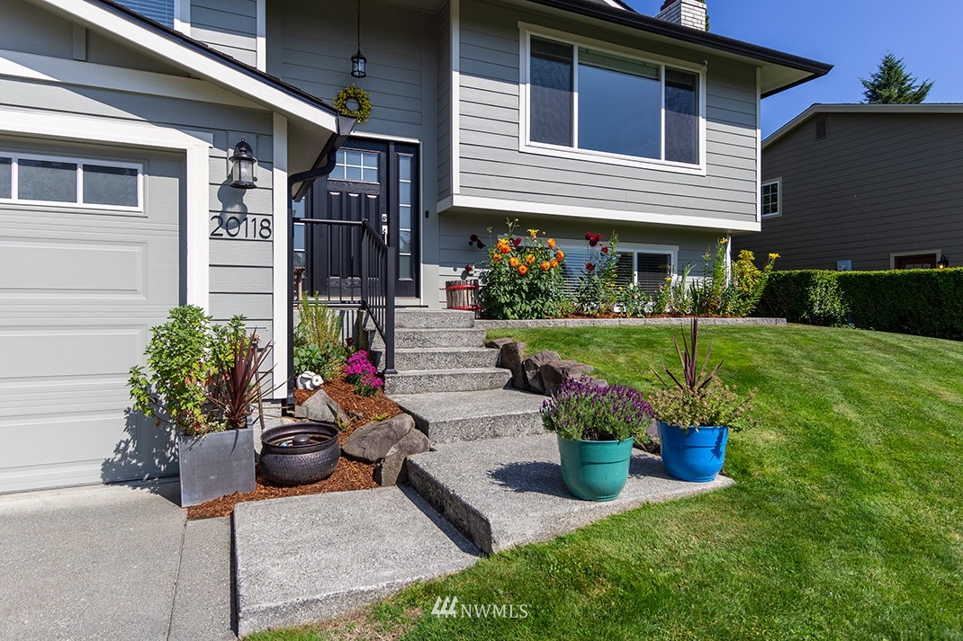 20118 103rd Place Northeast Bothell, WA 98011 - Photo 1 of 40 a front view of a house with a porch and a garden