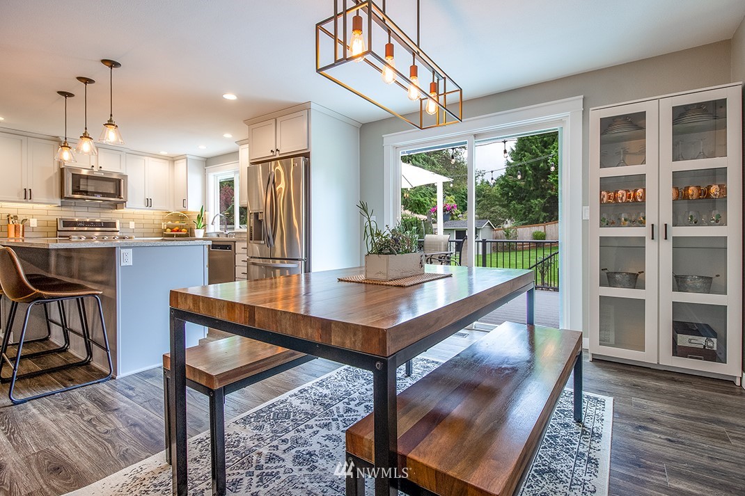 20118 103rd Place Northeast Bothell, WA 98011 - Photo 12 of 40 a view of a dining room with furniture window and wooden floor
