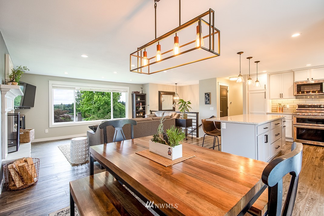 20118 103rd Place Northeast Bothell, WA 98011 - Photo 13 of 40 a view of a dining room with furniture a chandelier and wooden floor
