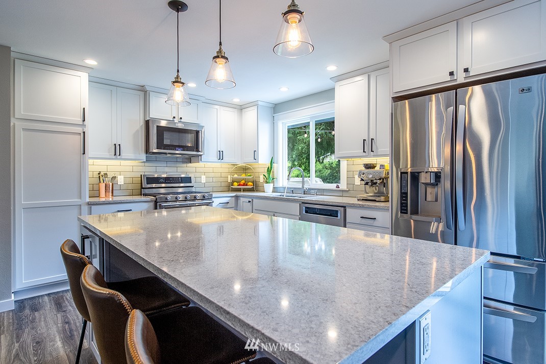 20118 103rd Place Northeast Bothell, WA 98011 - Photo 15 of 40 a large kitchen with kitchen island a large counter top space appliances and a center island