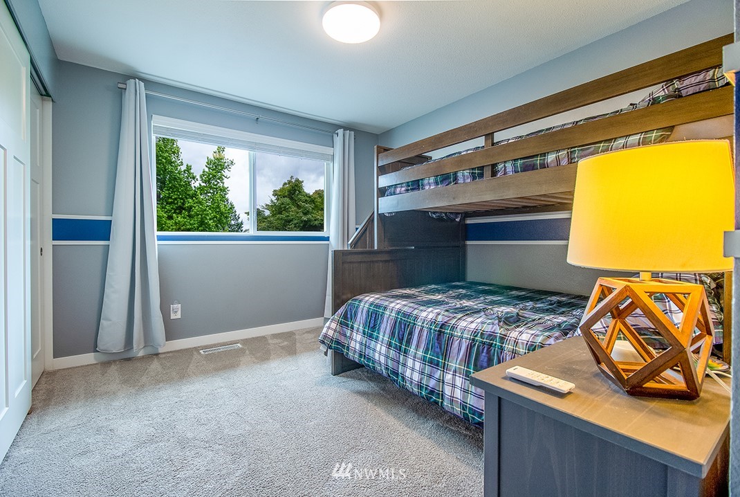 20118 103rd Place Northeast Bothell, WA 98011 - Photo 20 of 40 a bedroom with a bed and wooden floor