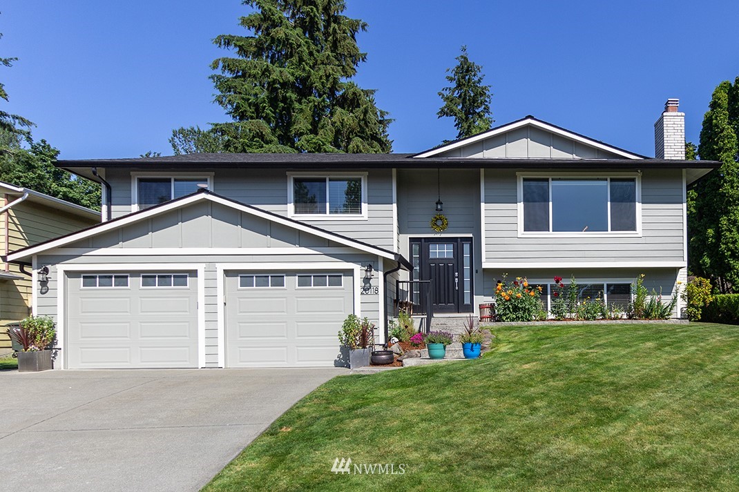 20118 103rd Place Northeast Bothell, WA 98011 - Photo 3 of 40 a front view of a house with a yard