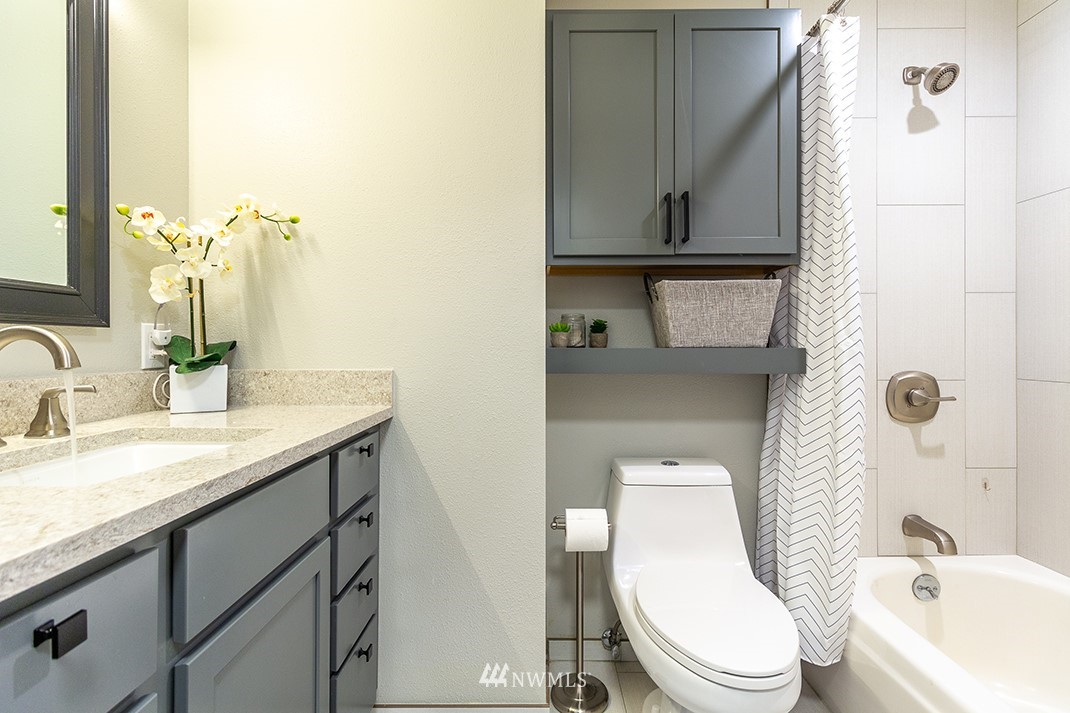 20118 103rd Place Northeast Bothell, WA 98011 - Photo 22 of 40 a bathroom with a granite countertop toilet sink and mirror