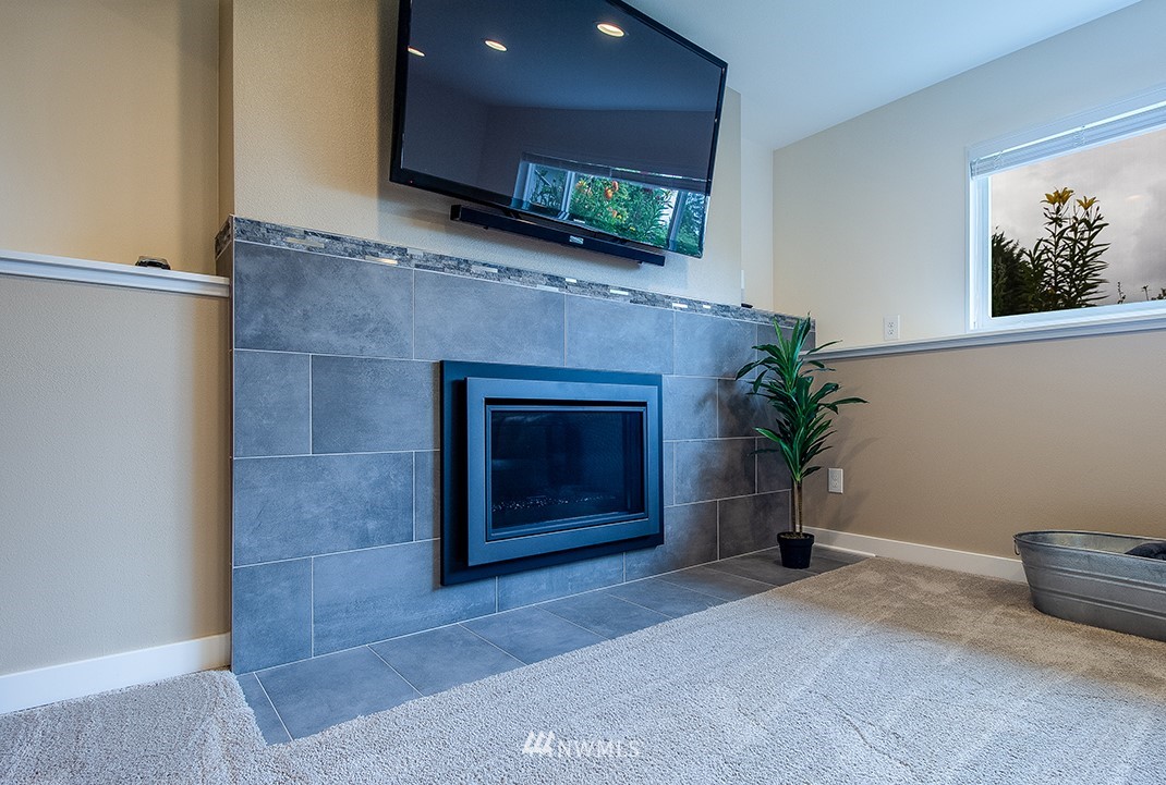 20118 103rd Place Northeast Bothell, WA 98011 - Photo 25 of 40 a living room with a fireplace and a potted plant