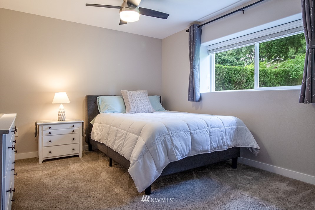 20118 103rd Place Northeast Bothell, WA 98011 - Photo 27 of 40 a bedroom with a bed dresser and a window