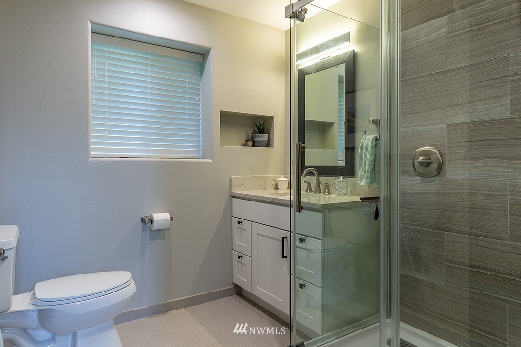 20118 103rd Place Northeast Bothell, WA 98011 - Photo 28 of 40 a bathroom with a granite countertop sink toilet and shower