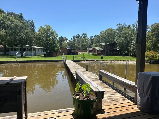 a view of a lake with a deck and a garden