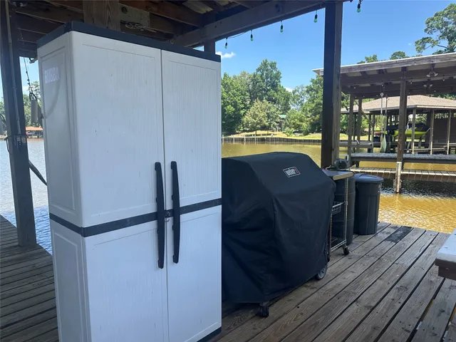 a view of a balcony with furniture and wooden floor