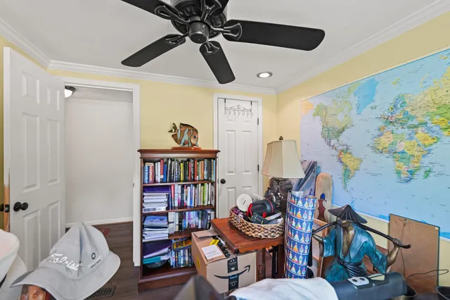 a living room with furniture and a book shelf