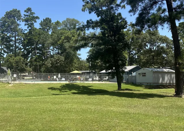 a view of a house with swimming pool and a yard