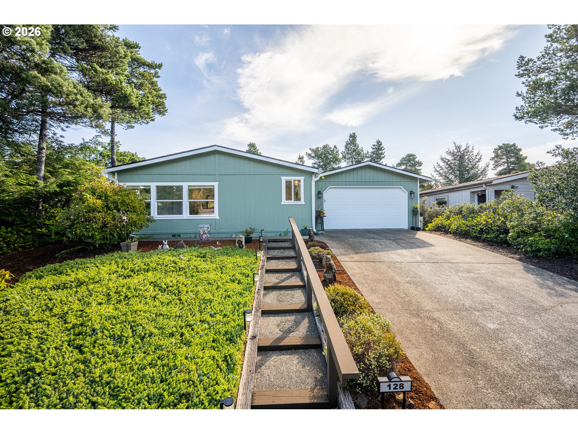 128 Evergreen Lane Florence, OR 97439 - Photo 1 of 34 a view of a house with a yard and potted plants