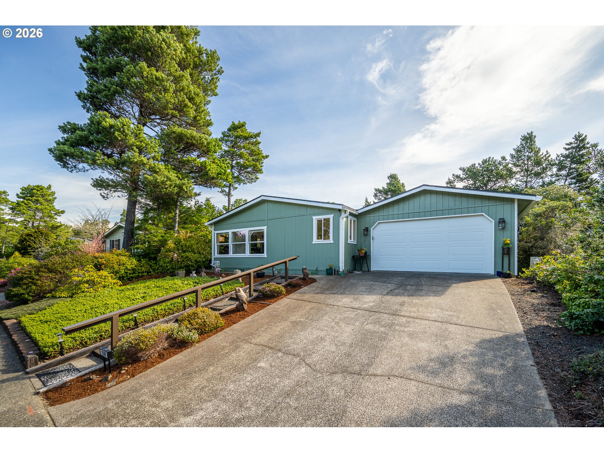 128 Evergreen Lane Florence, OR 97439 - Photo 2 of 34 a view of backyard with a garden and trees