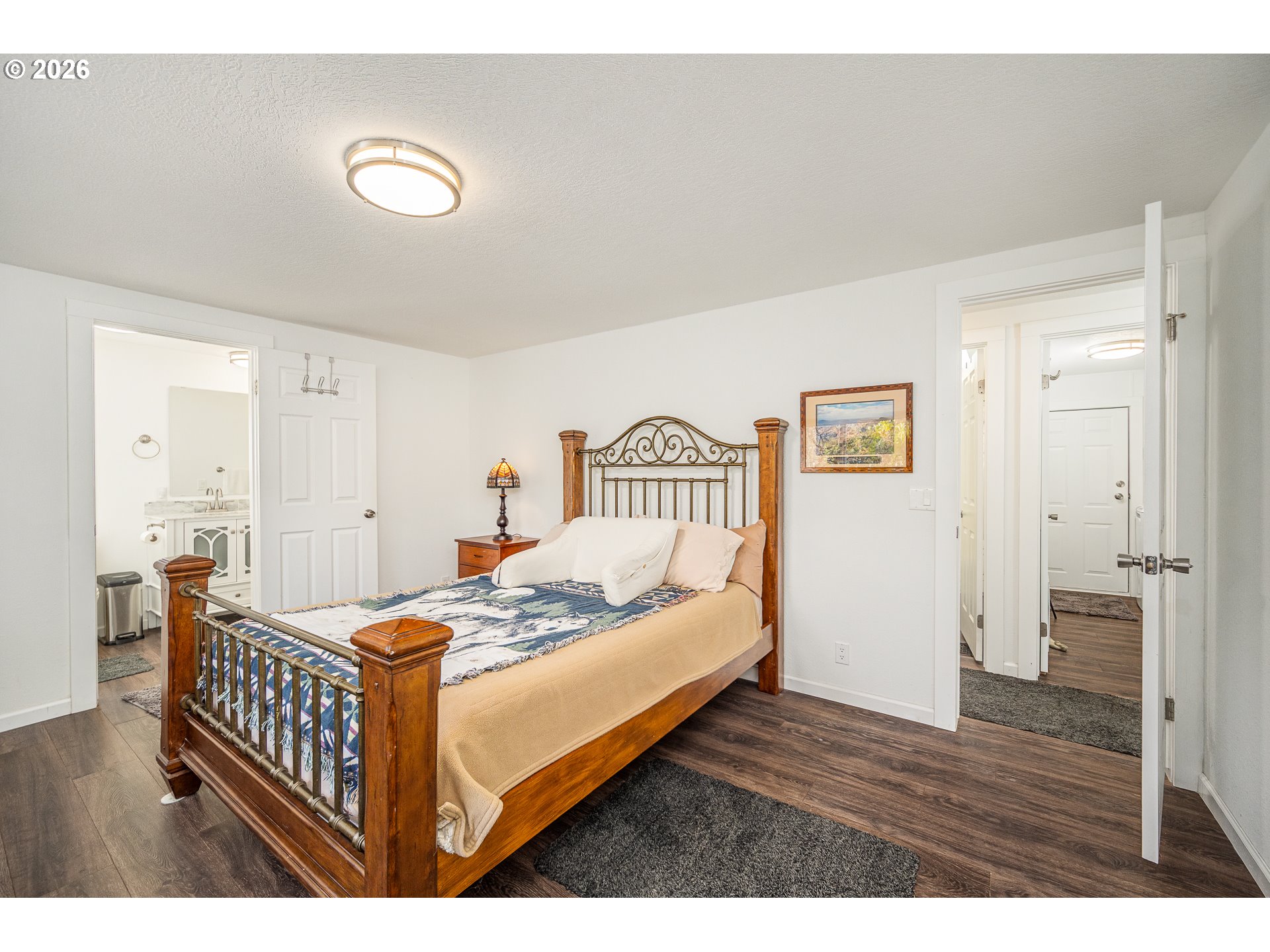 128 Evergreen Lane Florence, OR 97439 - Photo 21 of 34 a bedroom with a bed and wooden floor