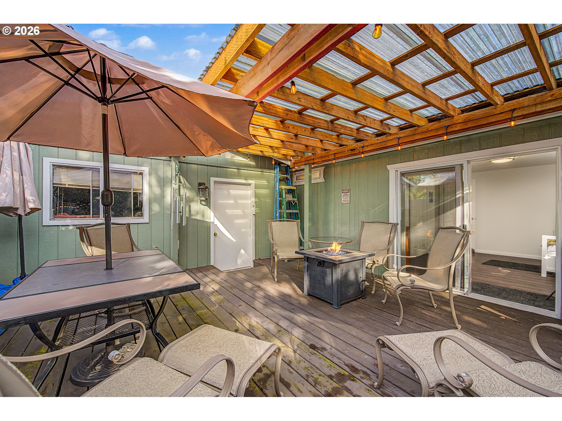 128 Evergreen Lane Florence, OR 97439 - Photo 26 of 34 a view of a patio with table and chairs under an umbrella