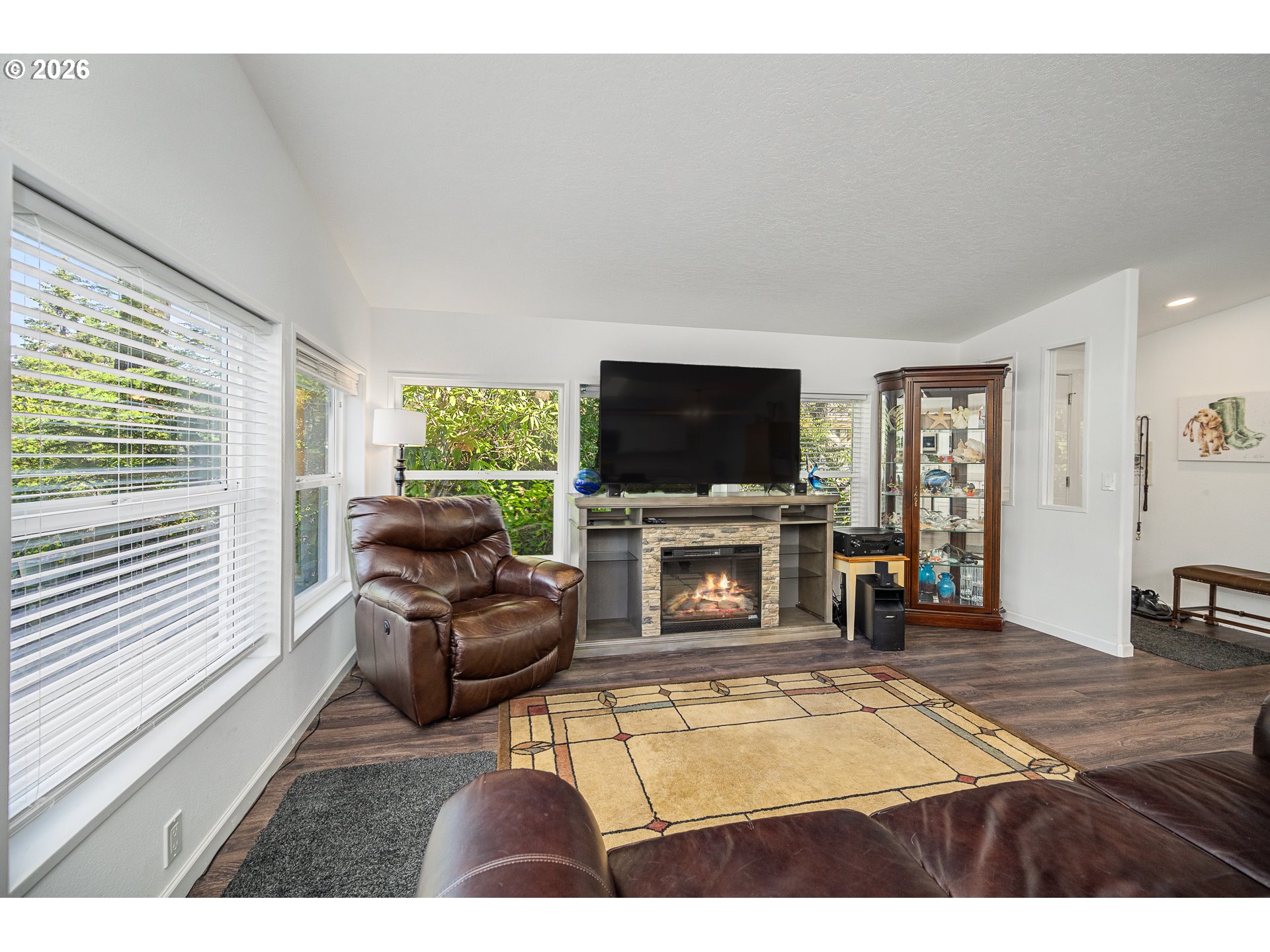 128 Evergreen Lane Florence, OR 97439 - Photo 7 of 34 a living room with furniture a flat screen tv and a fireplace