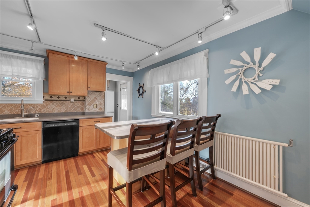 113 Bay State Road Worcester, MA 01606 - Photo 19 of 34 a dining hall with stainless steel appliances granite countertop a stove a sink dishwasher and a stove with wooden floor