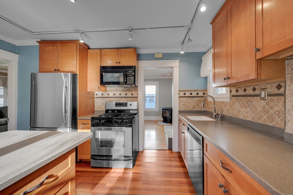 113 Bay State Road Worcester, MA 01606 - Photo 21 of 34 a kitchen with stainless steel appliances a sink cabinets and a counter top space