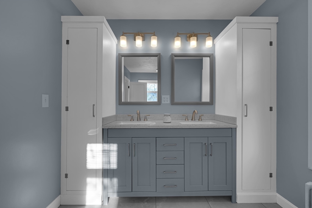 113 Bay State Road Worcester, MA 01606 - Photo 24 of 34 a bathroom with a granite countertop sink and a mirror