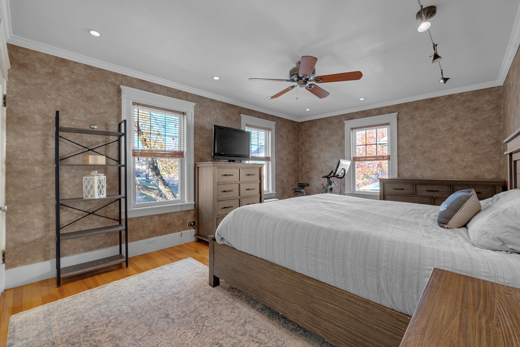 113 Bay State Road Worcester, MA 01606 - Photo 25 of 34 a bedroom with a bed and wooden floor