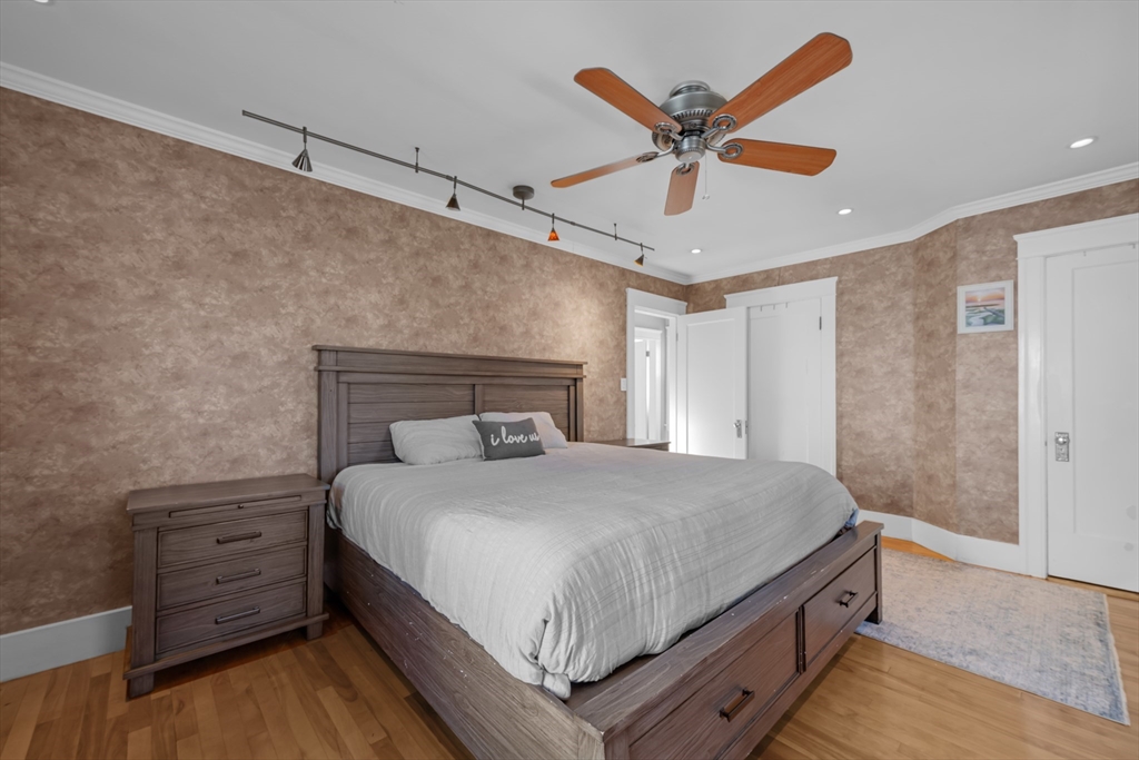 113 Bay State Road Worcester, MA 01606 - Photo 27 of 34 a bedroom with a bed and ceiling fan