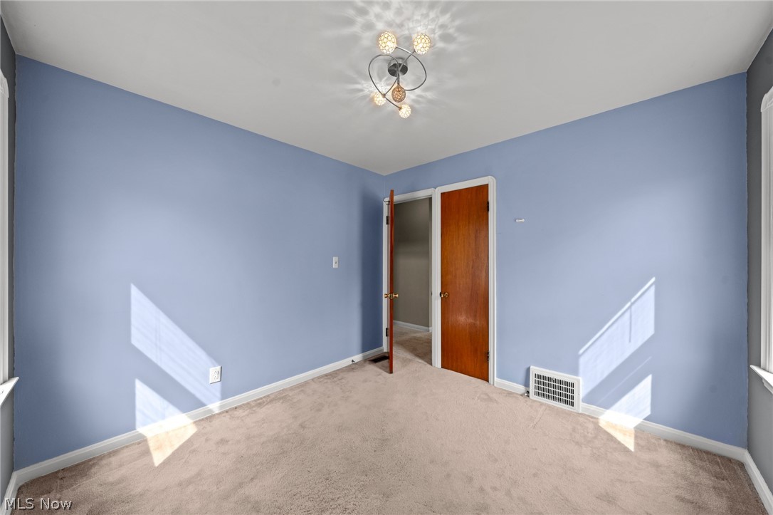 3261 Berea Road Cleveland, OH 44111 - Photo 12 of 43 Plush carpeting, contemporary ceiling fixture, and a wood-finish door