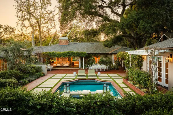 an aerial view of a house with swimming pool and patio