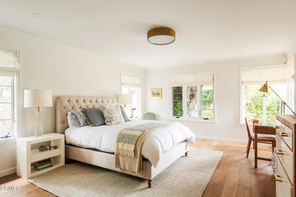 a bedroom with a bed and a view of living room