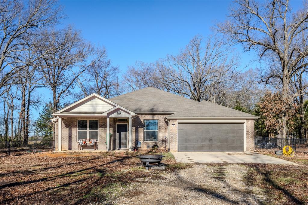 8676 State Highway Edgewood, TX 75117 - Photo 1 of 37 a front view of a house with a yard and garage