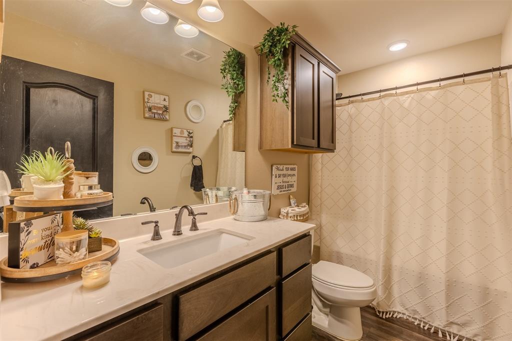 8676 State Highway Edgewood, TX 75117 - Photo 21 of 37 a bathroom with a granite countertop sink and a mirror