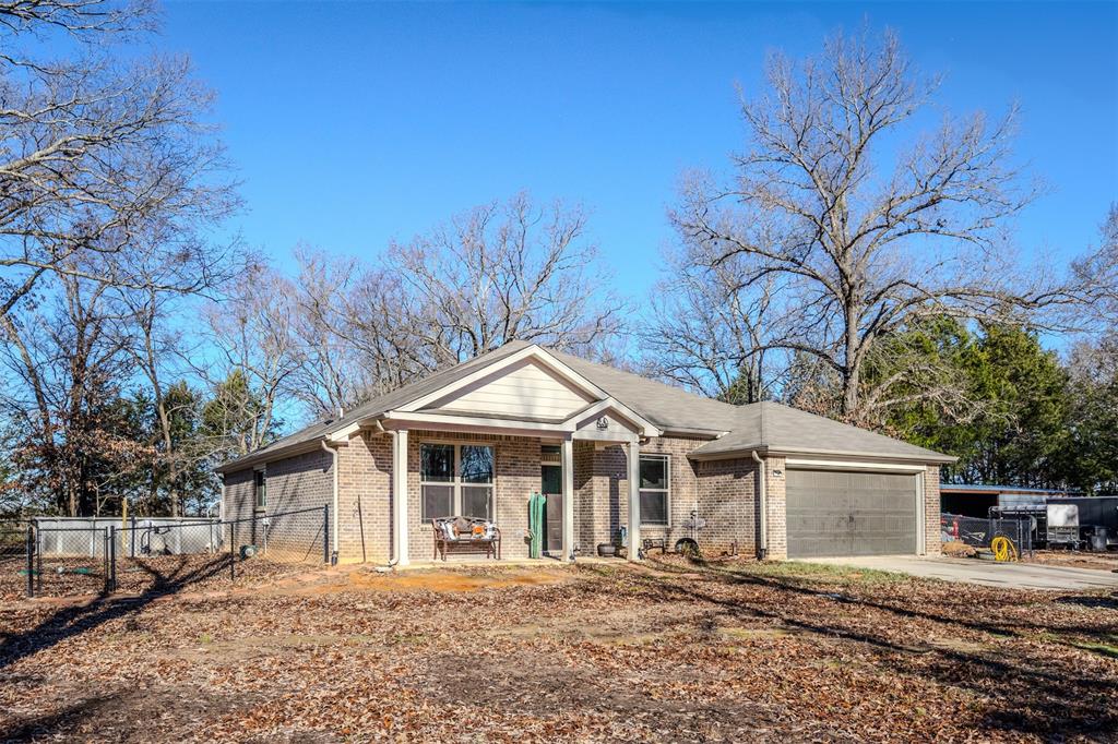 8676 State Highway Edgewood, TX 75117 - Photo 3 of 37 a front view of a house with a yard