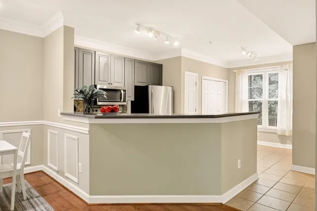 a kitchen with stainless steel appliances granite countertop a refrigerator and a sink