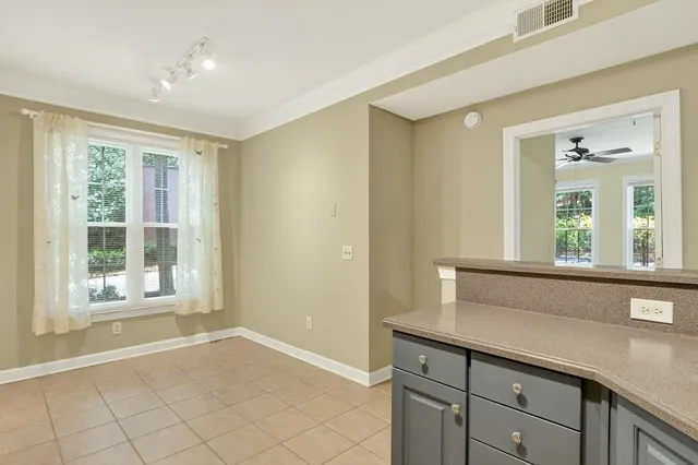 a living room with a wooden floor and large window