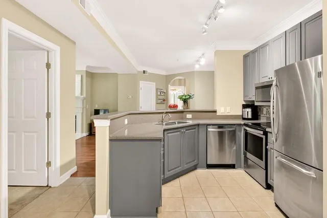 a kitchen with stainless steel appliances granite countertop a refrigerator and a sink