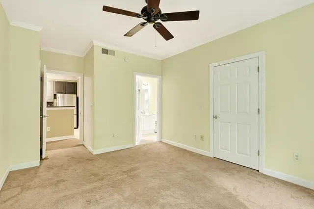 an empty room and chandelier fan in a room