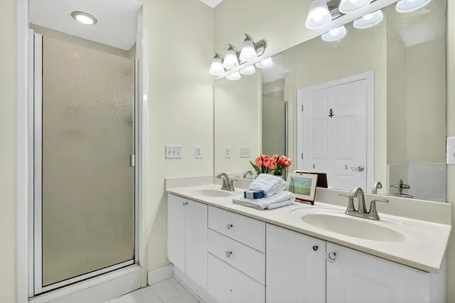a bathroom with a sink double vanity and a mirror