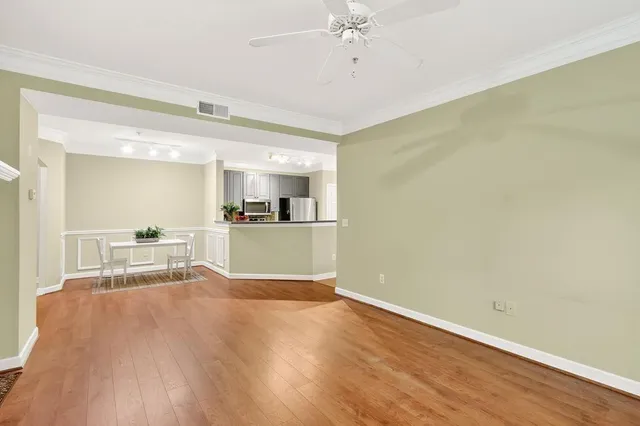 a view of a kitchen with wooden floor and a sink