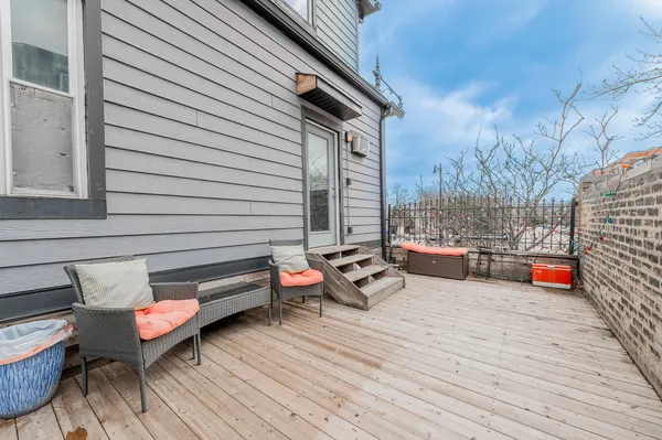 a backyard of a house with barbeque oven table and chairs