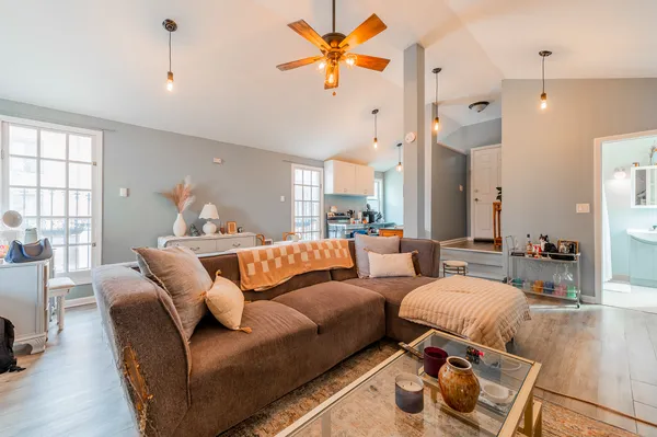 a living room with furniture and wooden floor