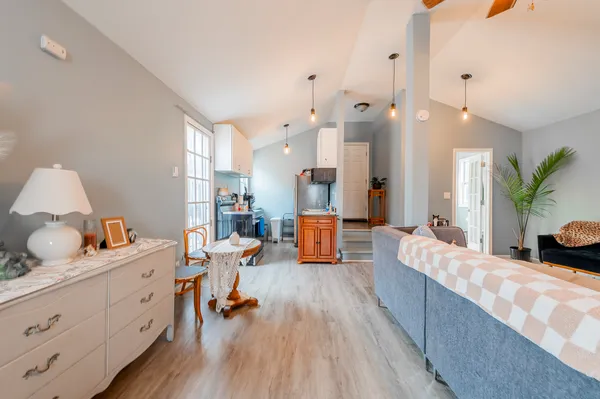 a living room with furniture and wooden floor