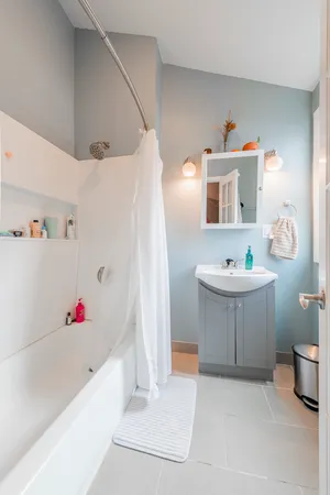 a bathroom with a tub sink and a mirror