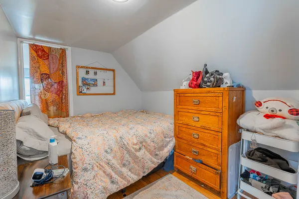 a bedroom with a bed and a desk