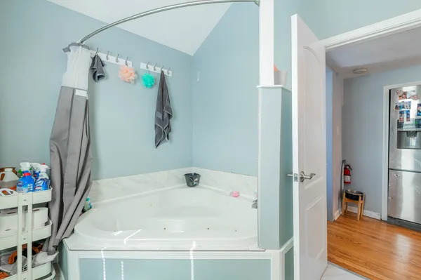 a room with stainless steel appliances kitchen island granite countertop a table and chairs in it
