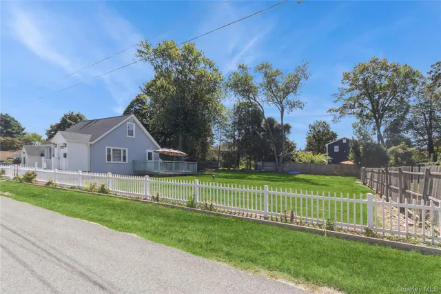 a view of a house with a big yard and a fountain