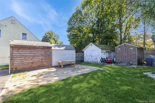 a backyard of a house with table and chairs