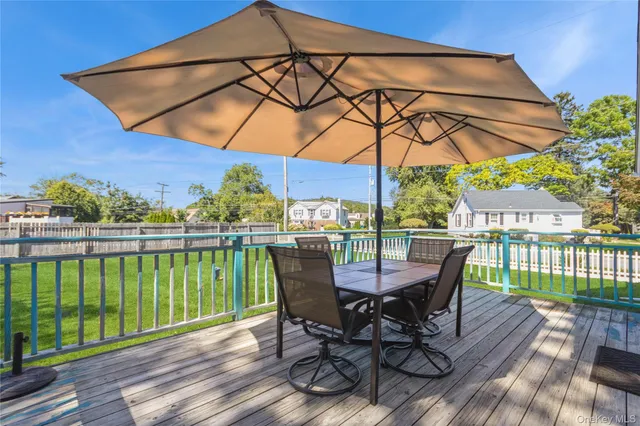 a view of a chair and table on the deck