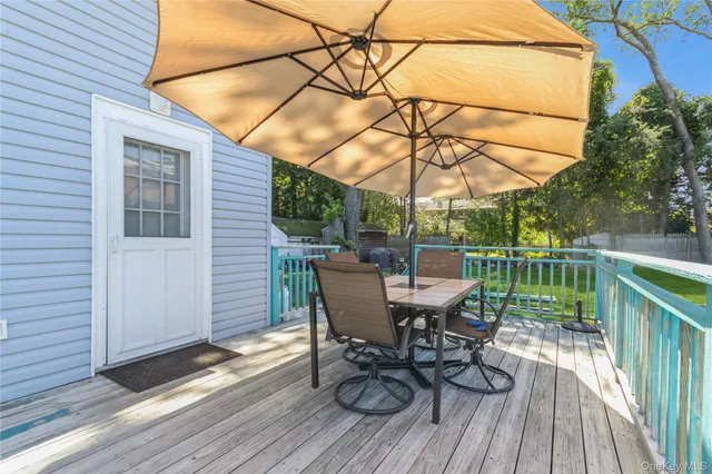 a view of a deck with table and chairs and wooden floor